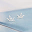 Sterling silver origami crane earrings poised delicately, capturing the spirit of Japanese art in a chic, wearable form.