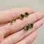 Chic petit emerald crystal studs with 14k yellow gold plating on sterling silver, perfect for adding a touch of elegance and trendy flair to any outfit.