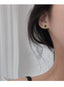 Chic petit emerald crystal studs with 14k yellow gold plating on sterling silver, perfect for adding a touch of elegance and trendy flair to any outfit.