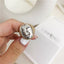 Gold and silver-toned statement ring with an abstract Picasso-inspired face design, a fusion of classic art and modern fashion.