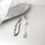 Modern abstract silhouette earrings with a lustrous pearl drop, combining artistic design with timeless pearl elegance.