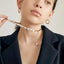 A stylish baroque pearl necklace with a golden chain accent, exuding a blend of classic beauty and modern sophistication.