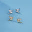 Tiny pterodactyl dragon stud earrings in sterling silver with 14k gold plating and cubic zirconia accents.