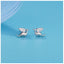 Tiny pterodactyl dragon stud earrings in sterling silver with 14k gold plating and cubic zirconia accents.