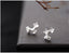 Delicate sakura sterling silver earrings featuring a cherry blossom flower branch design, 11mm x 7mm in size.