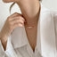 A graceful pearl necklace against a backdrop of delicate white fabric, epitomizing elegance.