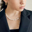 A stylish baroque pearl necklace with a golden chain accent, exuding a blend of classic beauty and modern sophistication.
