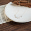 Minimalist pearl necklace against a rustic backdrop, highlighting its simple beauty.