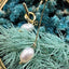 Subtle yet sophisticated minimalist pearl drop earrings with an elegant gold finish, perfect for any occasion.