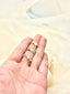 A gold necklace with a pinkie promise hand gesture pendant, embodying a timeless pledge and refined design.