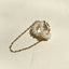 A magnetic pearl cuff earring with a cascading chain of pearls, combining classic elegance with innovative design.