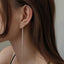 Elegant silver tassel dangle earrings, showcasing a blend of modern design and classic charm, ideal for fashion-forward individuals