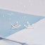 Sterling silver origami crane earrings poised delicately, capturing the spirit of Japanese art in a chic, wearable form.