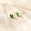 Chic petit emerald crystal studs with 14k yellow gold plating on sterling silver, perfect for adding a touch of elegance and trendy flair to any outfit.
