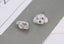Charming stud earrings shaped like a dog's head, adorned with shimmering crystals and deep black eyes, offering a whimsical yet elegant touch.