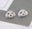 Charming stud earrings shaped like a dog's head, adorned with shimmering crystals and deep black eyes, offering a whimsical yet elegant touch.